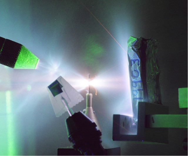 An ultrahigh intensity laser pulse at TRIDENT interacting with a molybdenum target to produce a proton beam with energies greater than 50 million electron volts, as well as an intense burst of X-rays lasting a few picoseconds.