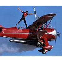 Pilot Jim Franklin and his wingwalker son Kyle perform in their Waco biplane, 1997