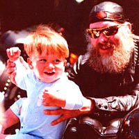 Biker and toddler enjoy the parade, 1996