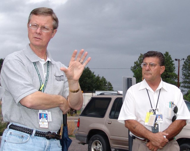 Bob McQuinn, left, associate director for Nuclear and High Hazards Operations (ADNHHO), asks questions about facility conditions at a recent management walkaround at Technical Area 16. Jim Whittington, a facility coordinator in Engineering Facility Operations (MSS-EFO) listens to McQuinn's comments on this recent stormy day.