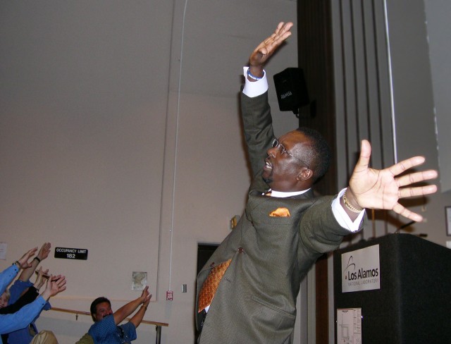 Derius Swinton leads Lab employees with hand movements as he tells a story during his talk on Tuesday in the Physics Building Auditorium at Technical Area 3.