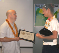 Chief Lancaster presents Kristen Coelho with a plaque in recognition of the 535 hours she has volunteered so far this fiscal year at the NRCS Hoolehua Plant Materials Center (PMC) located on the island of Molokai. 