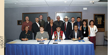 Seated at the table during the signing of the agreement are (from left to right) President Alex White Plume, Oglala Sioux Tribe; Vice-Chairwoman Roxanne Gourneau, Assiniboine and Sioux Tribes; President Leo Lee Pino, Ramah Navajo Chapter; and Councilman Archie Fool Bear, Standing Rock Sioux Tribe.