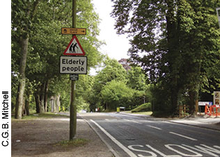 This crossing in Hampshire, Britain, is especially helpful to older people. The prominently painted "SLOW" on the roadway get drivers' attention, as does the "Elderly people" sign. Photo: Highway Safety Group, Environment Department, Hampshire County Council.