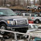 trucks are loaded on car haulers (©AP Images)