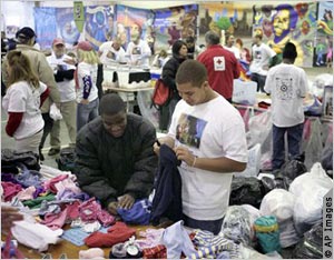 Volunteers sorting clothing (AP Images)