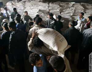 Palestinians receive aid packages in Gaza City (AP Images)