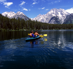 photo: kayakers with mountain in background, on a stream