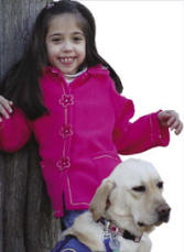 Photo of child with cerebral palsy and canine companion