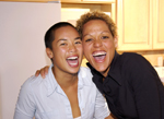 Image of female couple smiling.