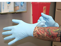 Body art worker putting on gloves