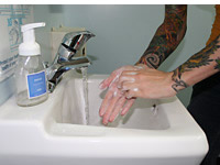 Body art worker washing hands