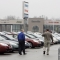 two people on car lot (AP Images)