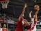 Steve Nash goes for a basketball shot while Houston Rocket star Yao Ming tries to block