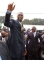 Dikembe Mutombo waves as he stands with President Joseph Kabila of the Democratic Republic of Congo