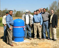 (from left) urban conservationist Bill McGraw, NRCS area conservationist Wesley Kerr, landowner Donnie Travis, NRCS district conservationists Mike McNair and Paul Caves, Chief Knight, NRCS soil conservation technician Danny Box, Mississippi Soil and Water Conservation Commission member Don Underwood, Mississippi NRCS State Conservationist Homer Wilkes, and NRCS Special Assistant to the Chief Sam Thornton