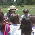 Park ranger talking to a group of children.