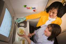 Photo: Food technologist instructs taste tester on evaluating sensory qualities of fresh-cut PQSL-treated Fuji apple slices. Link to photo information