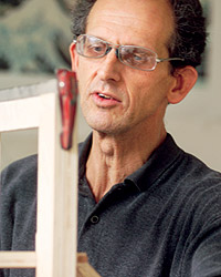 Architecture professor examining a wood model