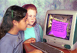 Photo: Two 4th grade students play nutrition computer game.