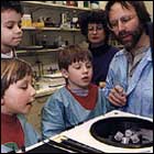 Photograph of Michael Iadarola with young visitors to the laboratory, mid-1990s.