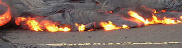 Lava flows on the road burning the asphalt.