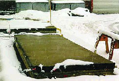 Photo of concrete slabs in the snow, slabs not covered with snow