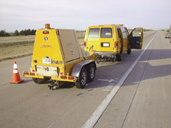 Photo of a Long Term Pavement Performance Falling Weight Deflectometers is collecting deflection data from an LTPP test section