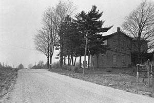 This 1928 photograph shows an old National Road tavern along an unimproved section of U.S. 40 in Indiana, just west of the Ohio State line.