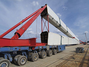 The remaining five steel caret- or wedge-shaped pylons that support the orthotropic steel Millau Viaduct with cable stays were prefabricated and then moved into place using high-tech self-propelled modular transporters (SPMTs) like the one shown here. Photo: Groupe EIFFAGE.