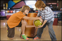 Photo: Two boys and a bowling ball