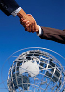 Handshake with globe in background