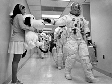 Apollo 10 commander Tom Stafford pats a stuffed Snoopy