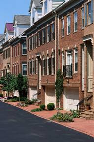 Photograph of single family townhomes with garages.