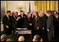 President George W. Bush shakes hands with U.S. Senator Arlen Specter, R. Pa., after signing H.R. 3199, USA PATRIOT Improvement and Reauthorization Act of 2005, Thursday, March 9, 2006 in the East Room of the White House. White House photo by Kimberlee Hewitt