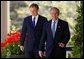 President George W. Bush and Prime Minister Tony Blair walk along the colonnade before a press conference in the Rose Garden of the White House on April 16, 2004.  White House photo by Paul Morse