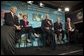 President George W. Bush participates in a conversation on the benefits of health care information technology with, from left, Anthony Principi, Secretary of Veterans Affairs, Marlene Miller, M.D. of John Hopkins Children's Center, Dennis Smith of VA Maryland Health Care System and Tommy Thompson, Secretary of Health and Human Services at the Department of Veterans Affairs Medical Center in Baltimore, Maryland on April 27, 2004.  White House photo by Paul Morse