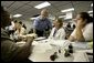 President George W. Bush visits with hurricane relief workers at Martin County Red Cross Headquarters in Stuart, Fla., Thursday, Sept. 30, 2004. "See, these volunteers show the true heart of America, because we're a compassionate people, we care when a neighbor hurts, we long to help somebody when help is needed," said the President. "They have the gratitude of all they've served, and they have the admiration for our whole country."  White House photo by Eric Draper