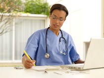 Health care provider working on laptop