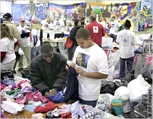 People sorting clothes on table (AP Images