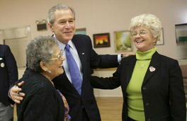 President George W. Bush greets Millie Martinez, right, and Ida Gonzalez at Bear Canyon Senior Center in Albuquerque, Tuesday, March 22, 2005, as he took his Conversation for Strengthening Social Security into New Mexico. The president reassured the approximately 30 breakfast guests that those born before 1950 will be unaffected by proposed reforms to the program.  White House photo by Eric Draper.
 