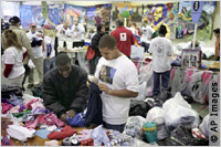 volunteers sorting clothing (AP Images)