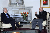 Biden and Karzai seated next to fireplace (AP Images)