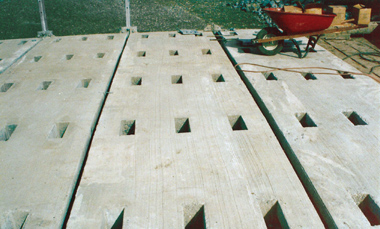 Photo: Precast concrete slab units with block-outs for placement of quick-settng mortar.