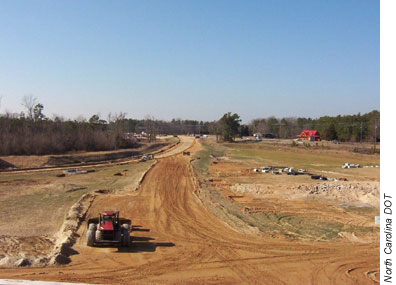 Photo: A tractor clears the land for the Knightdale Bypass on U.S. 64 in eastern North Carolina. 