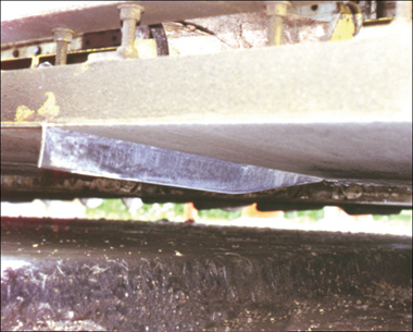 Photo: An early prototype of the joint-forming knife is mounted to the bottom of the paver pan. 