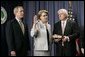 With President George W. Bush and her husband Robert Spellings by her side, Secretary of Education Margaret Spellings takes the oath of office during a ceremony at the Department of Education in Washington, D.C., Monday, Jan. 31, 2005. Secretary Spellings served as an Assistant to the President for Domestic Policy during the first term of the Bush administration.  White House photo by Paul Morse