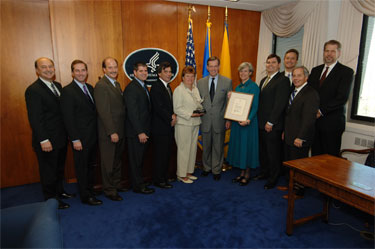 HHS Secretary Mike Leavitt presents the Presidential Award for Management Excellence. Pictured are (from left): Counselor to the Secretary for Human Services Policy Richard Campanelli, HHS Deputy Secretary Alex Azar, Assistant Secretary for Children and Families Wade F. Horn, Office of Public Health and Science's Brad Hendrick, ACF's David Jenkins, ACF's Diana King, Secretary Leavitt, ACF's Deborah Ferrenz, Director of the Office of Information Services Michael Curtis, HHS Chief Information Officer Charlie Havekost, Deputy Assistant Secretary for Administration Curt Coy and Deputy Chief of Staff Kerry Weems.