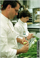Scheib working in kitchen (AP Images)