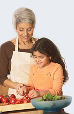 Image of a girl and her grandmother preparing healthy food